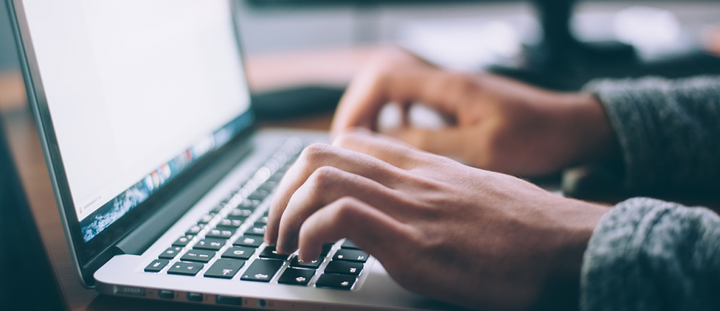 person typing on laptop